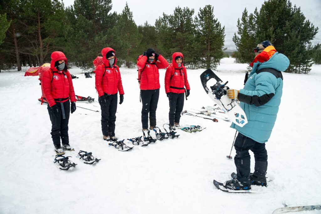 Getting to grips with our snow-shoes. 
Photo by Brodie Hood/Comic Relief