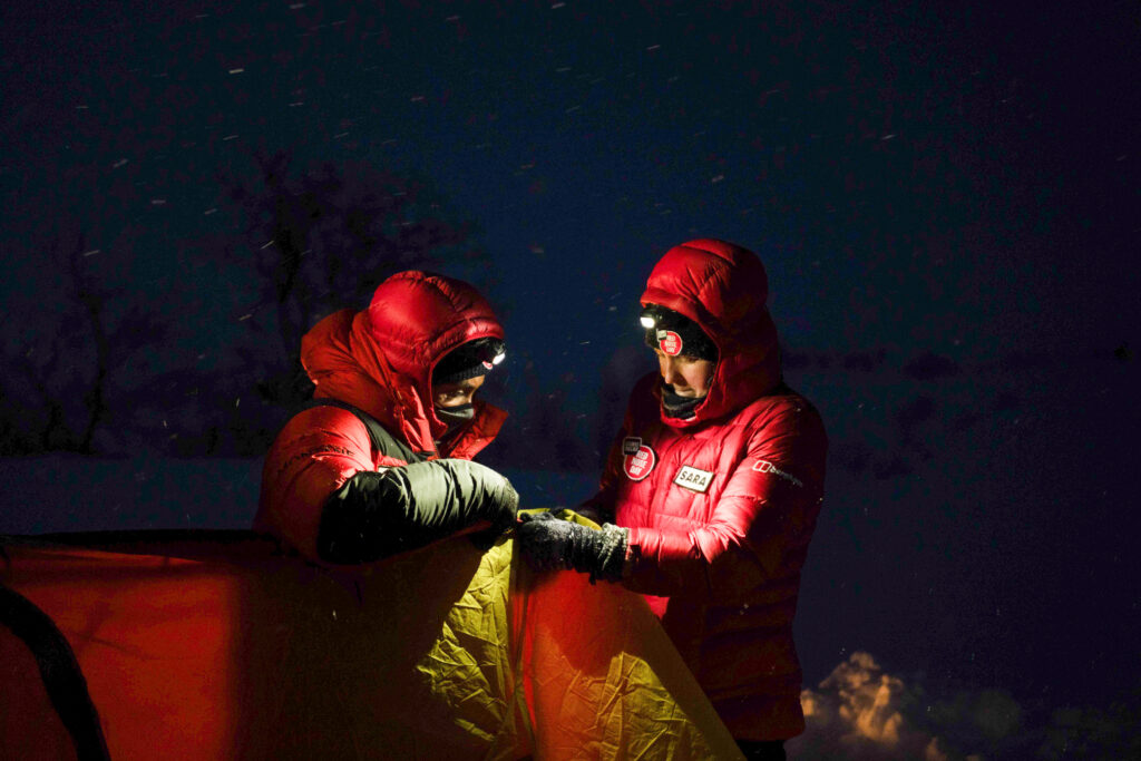 Alex and Sara putting up their tent in the dark after a gruelling second day.   (Photo by Brodie Hood/Comic Relief)